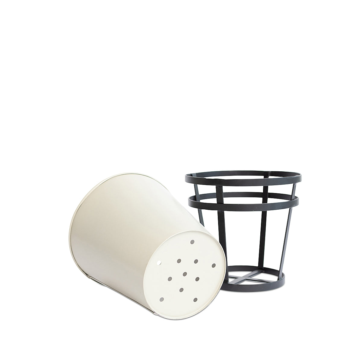 Off white Modern Rustic Framed Steel Planter, tipped on its side to show the drainage holes on the bottom, with its black metal frame standing next to it on a white background