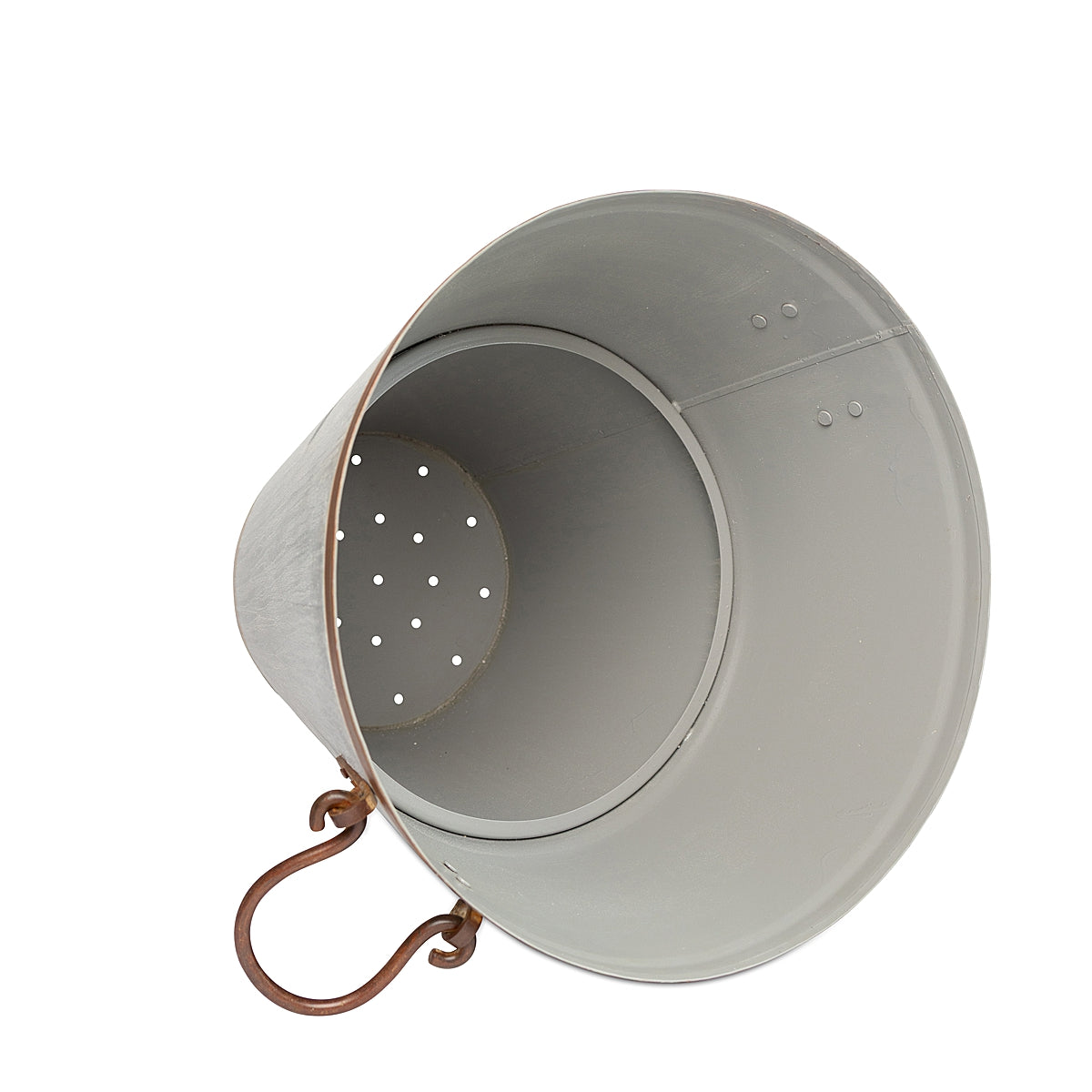 A galvanized tapered steel planter with a distressed finish and sturdy ring handles lying on its side showing inner details