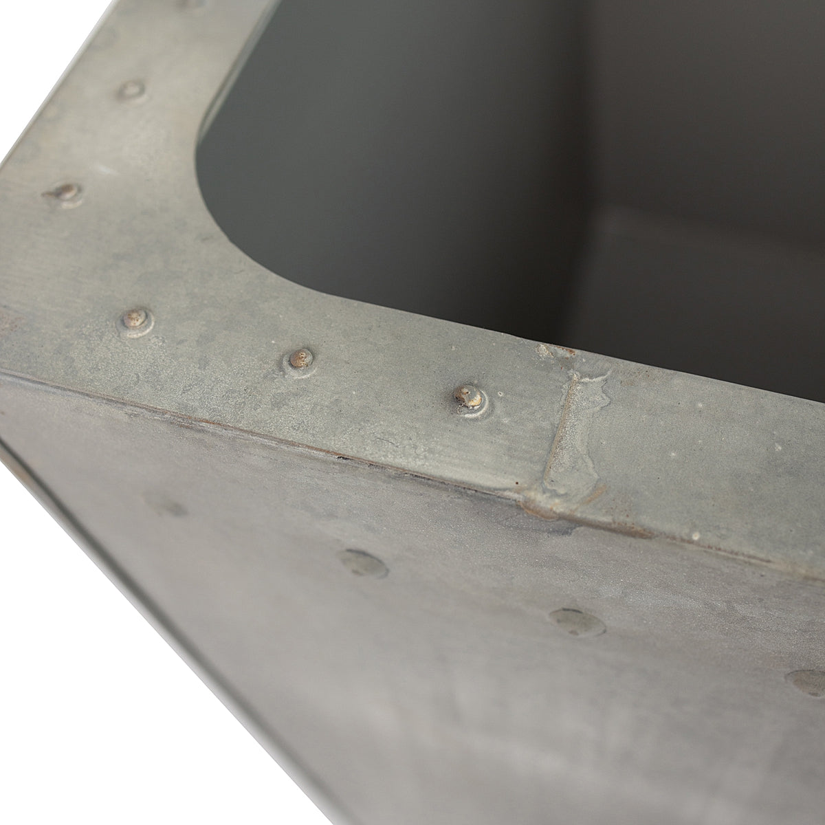 Close up of rivet details on the Rustic Rectangle Water Trough Metal Planter with a rugged galvanized steel finish and visible rivet details, inspired by traditional farm troughs on a white background.