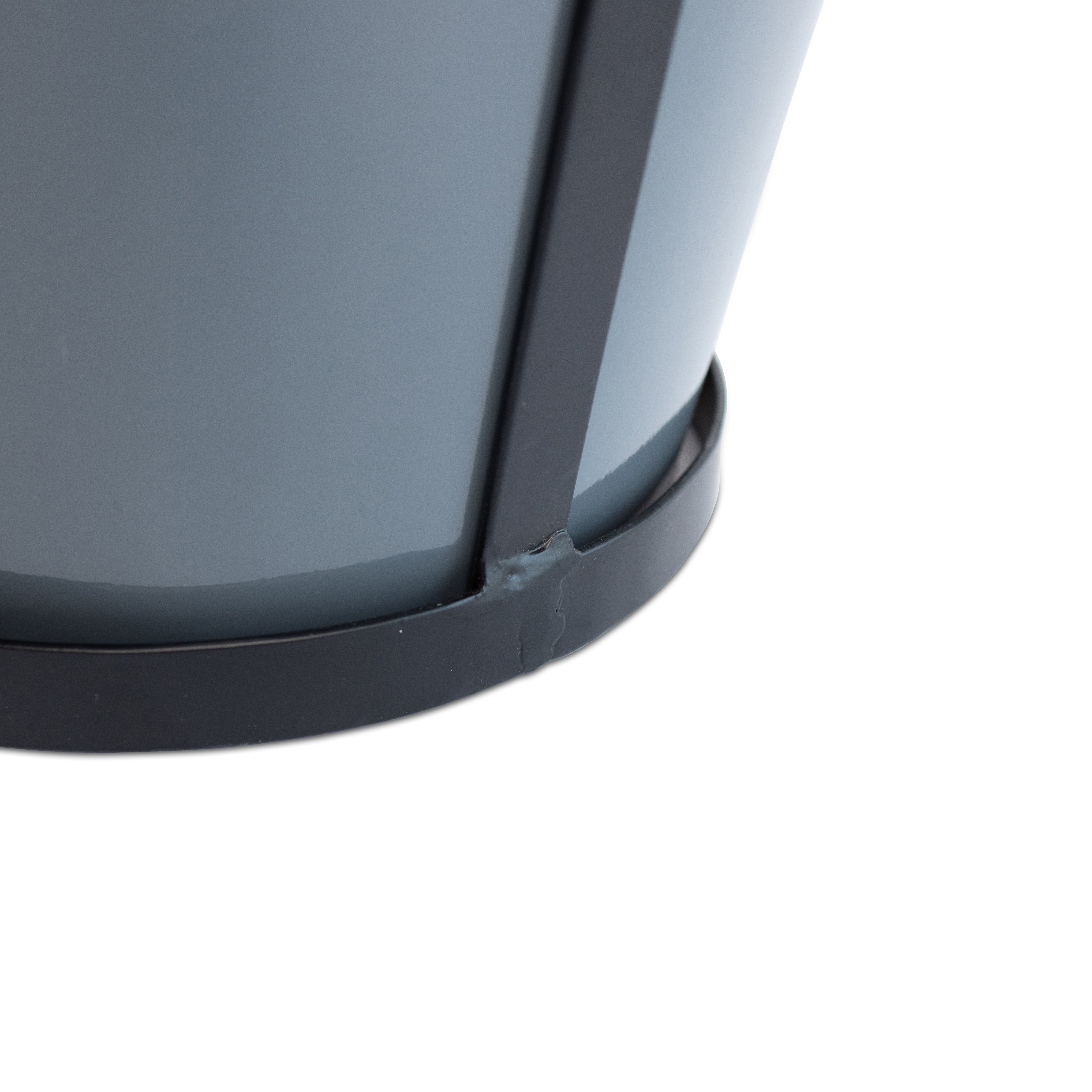 Close-up detail of the bottom of the gray modern rustic framed steel planter showing the construction and black metal frame