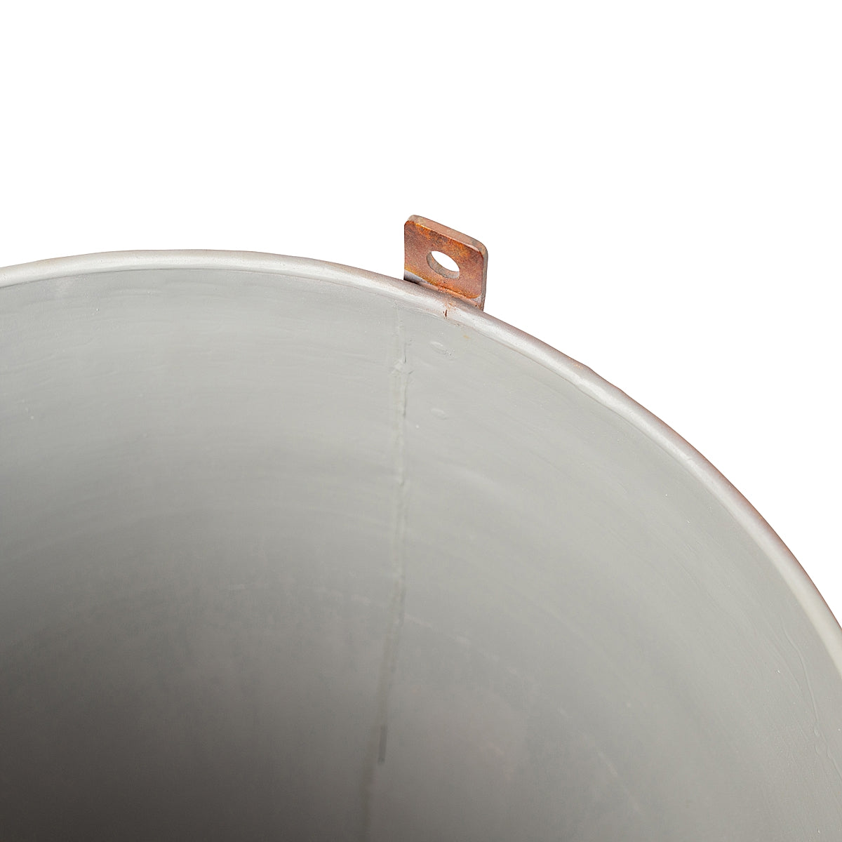 Close-up of inside coating of the Aged Round Ore Bucket Steel Planter with a rich aged rust patina finish, inspired by rugged, vintage ore buckets on a white background.