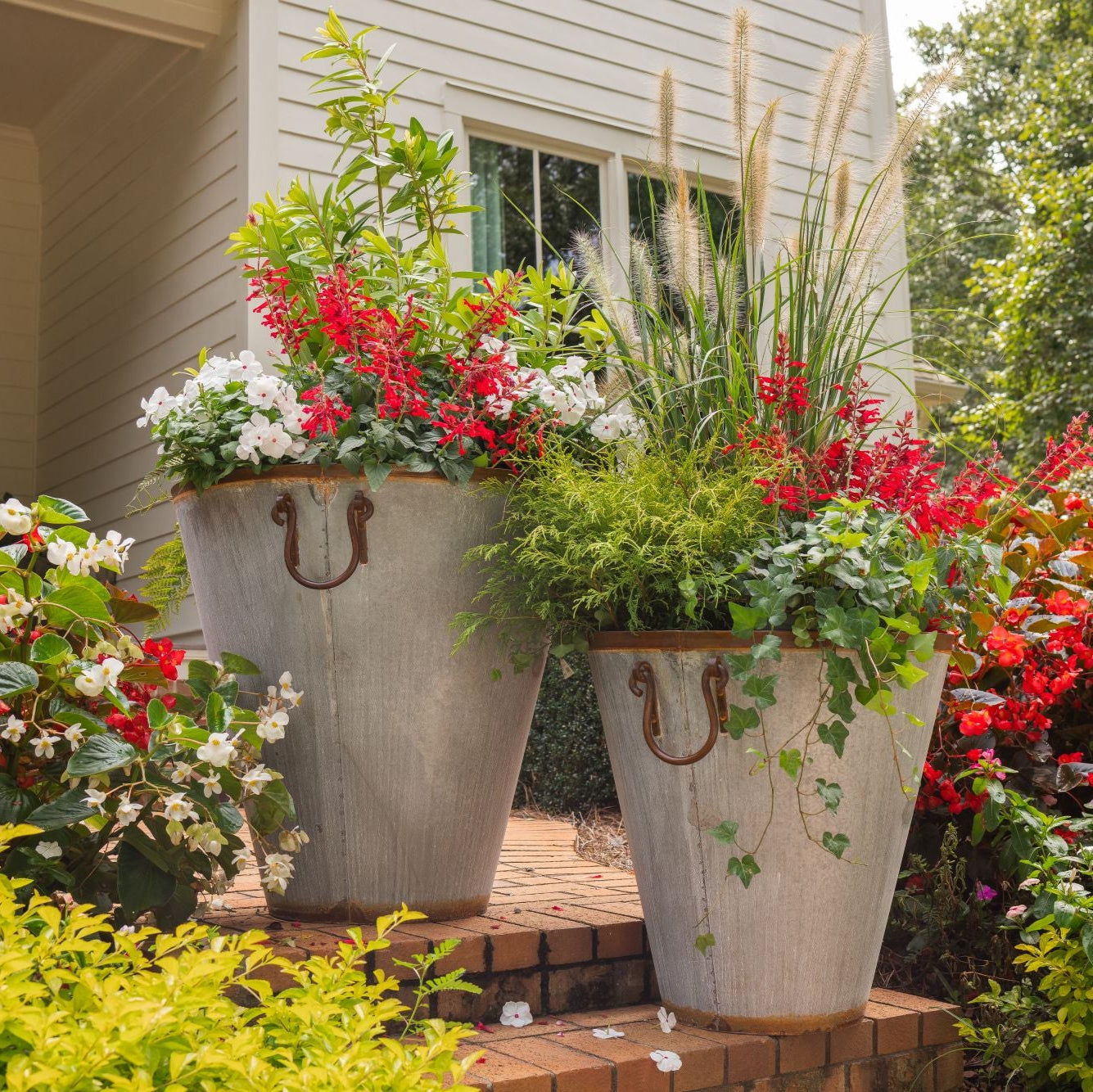 Large outdoor vintage pots with flowers in a garden setting .