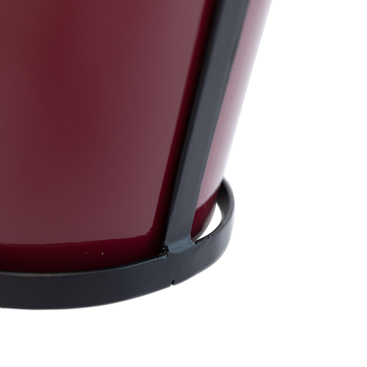 Close-up detail of the bottom of the red modern rustic framed steel planter showing the construction and black metal frame