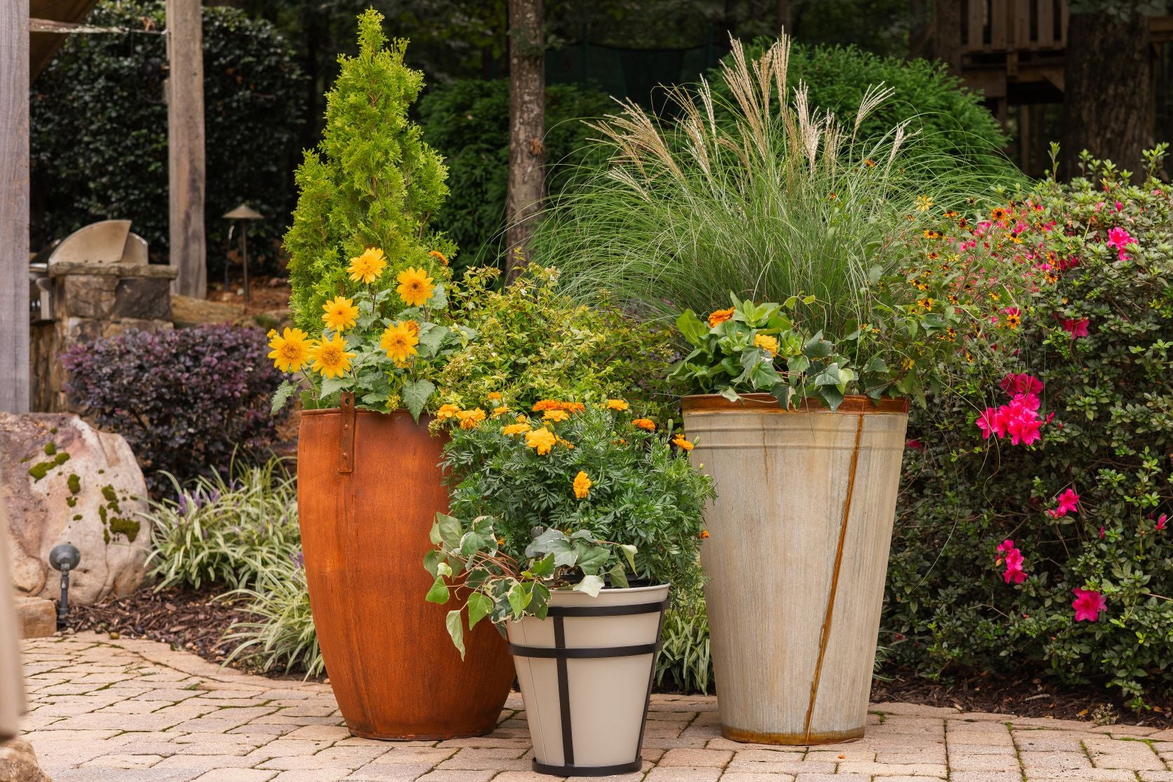 Decorative garden with potted plants and flowers on a stone patio