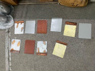 Color swatches arranged on a carpeted floor